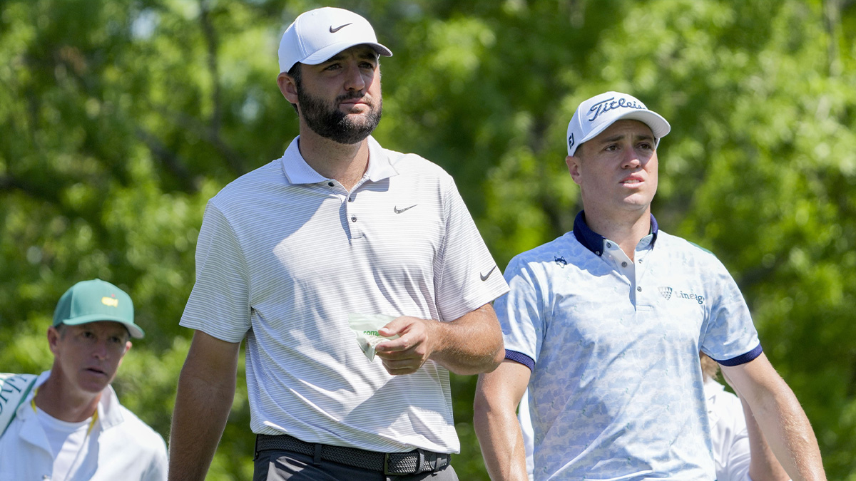 Scottie Scheffler and Justin Thomas walk off the no. 5 tee during the first round of the Masters Tournament.
